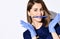 Portrait of young smiling woman doctor dentist in dark blue uniform and gloves with professional toothbrush in mouth