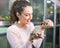 Portrait of young smiling woman holding turtles