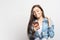 Portrait of young smiling woman with pink smartphone receiving some great news over white background. Lifestyle, people and techn