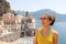 Portrait of young smiling woman with sunglasses in Atrani village, Amalfi Coast, Italy. Picture of female tourist