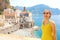 Portrait of young smiling woman with sunglasses in Atrani village, Amalfi Coast, Italy. Picture of female tourist in her summer