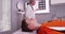 Portrait of young sports athlete lying down while doctor reviews xrays