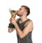 Portrait of young sportsman kissing gold trophy cup on white