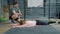 Portrait of young sportswoman exercising in gym working out with instructor on mat