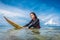 portrait of young sportswoman in wetsuit on surfing board in ocean at Nusa dua Beach