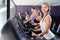 Portrait of young sporty females running on treadmill