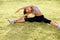 Portrait of Young Sporty Woman Doing Stretching Exercise. Athletic Workout.