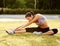 Portrait of Young Sporty Woman Doing Stretching Exercise. Athletic Workout.