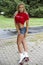 Portrait of young sporty woman with roller skate - outdoors