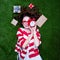 Portrait of a young styled redhead woman alarm clock and gifts