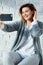 Portrait of a young stylish emotional smiling woman making selfie on smartphone