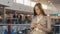 Portrait of a young teenager tourist woman visiting the city shopping using her smartphone device and smiling. Business