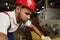 Portrait of young tired african american workman in cable production plant