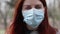 Portrait of a young tourist woman feeling sick,wearing a face mask against air pollution and coronavirus