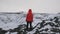 Portrait of young tourist woman in jacket and hat enjoying beautiful view of Kerid lake of Iceland. Woman admiring view