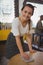 Portrait of young waitress cleaning table