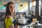 Portrait young waitress standing in cafe. girl the waiter holds in bunches a tray with utensils