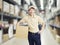 Portrait of a young warehouse worker carrying a carton box