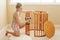Portrait of young white Caucasian happy woman assembling wooden baby crib in nursery at home