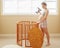 Portrait of young white Caucasian happy woman assembling wooden baby crib in nursery at home