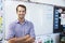 Portrait of young white male teacher in school classroom