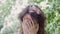 Portrait of a young woman amid Apple trees close-up. Laughter