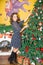 Portrait of young woman around a Christmas tree decorated. Girl on holiday new year