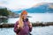 Portrait Young woman with backpack on fjord coast