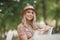 Portrait of a young woman, blonde, glasses, outdoors in the park