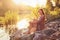 Portrait of young woman in casual summer dress, sitting on rocks near river, strong sunset backlight with nice bokeh