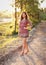 Portrait of young woman in casual summer dress, strong sunset backlight with nice bokeh