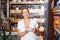 Portrait of young woman customer looking tools with note list in build store