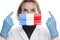 Portrait of a young woman doctor with medical protective mask with the image of the flag of France. Crisis, quarantine, recession