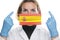 Portrait of a young woman doctor with medical protective mask with the image of the flag of Spain. Crisis, quarantine, recession