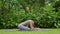 Portrait of a young woman doing yoga in the garden for a workout. Concept of lifestyle fitness and healthy. Asian women are