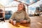 Portrait of a young woman with dreadlocks drinking coffee in a cafe and using a smartphone. The concept of business and