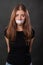 Portrait of a young woman with duct tape sealed in her mouth, restriction of freedom of speech and censored