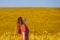 Portrait of young woman enjoying blooming mustard field