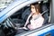 Portrait of young woman fasten seat belt in her car