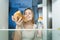 Portrait of young woman felling hungry at night choosing between high-calorie pizza and bottle of water