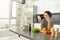 Portrait of young woman food blogger, posting on social media recipe, vegan salad, standing in the kitchen with