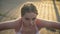 Portrait of young woman with freckles on pretty face doing sport exercises at summer evening