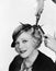 Portrait of a young woman getting her hair curled with an iron