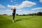 Portrait of young woman golfer, back view