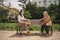 Portrait of young woman with grandmother outdoors in city, covid-19 and social distancing concept.