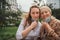 Portrait of young woman with grandmother outdoors in city, life after covid-19 vaccination.