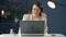 Portrait of a young woman in a headset working at a laptop. Polite call center operator. Business woman communicates