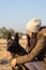 Portrait of a young woman and her adorable dutch shepherd dog in a field at countryside