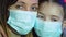 Portrait of young woman and her daughter wearing protective medical mask during virus epidemic