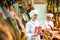 Portrait of young woman jamoneria worker with pack of ham